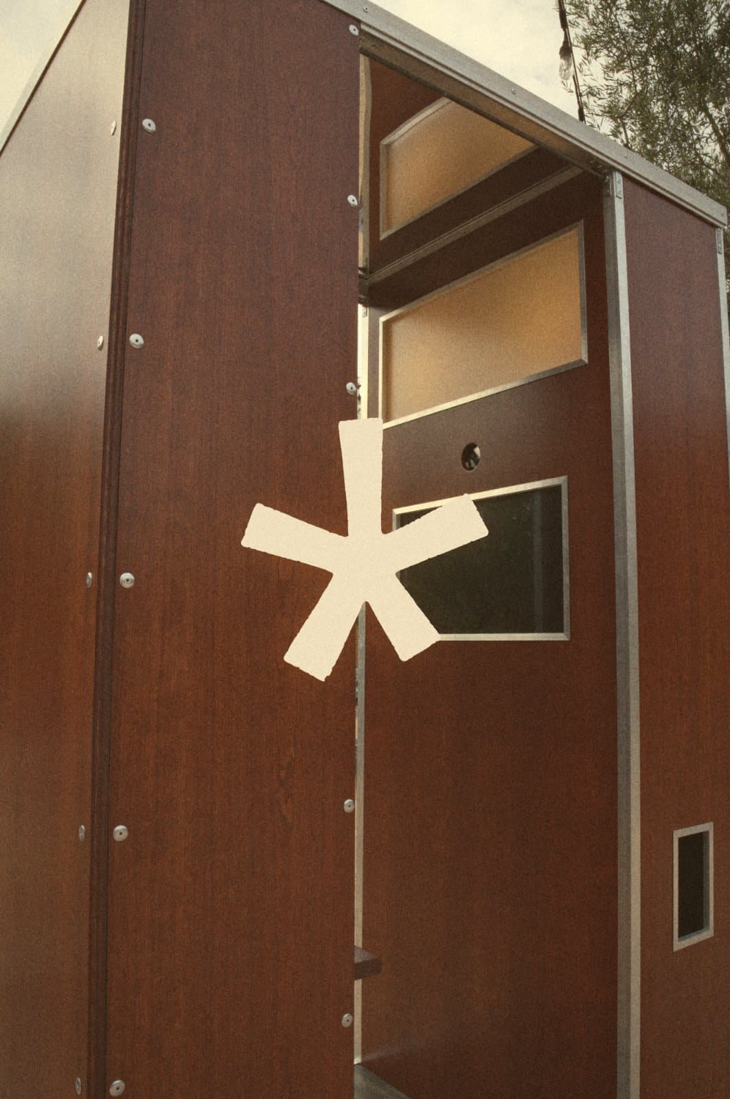 Custom Le Booth photo booth in walnut finish with the Le Booth asterisk mark