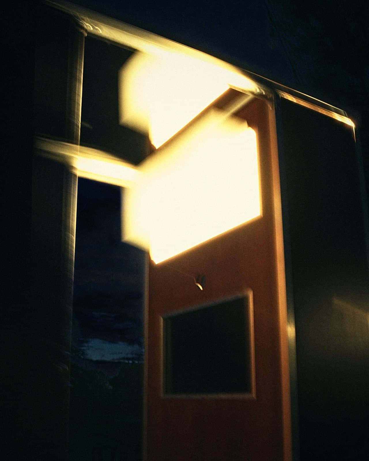 Long-exposure night shot of the booth glowing warm from within